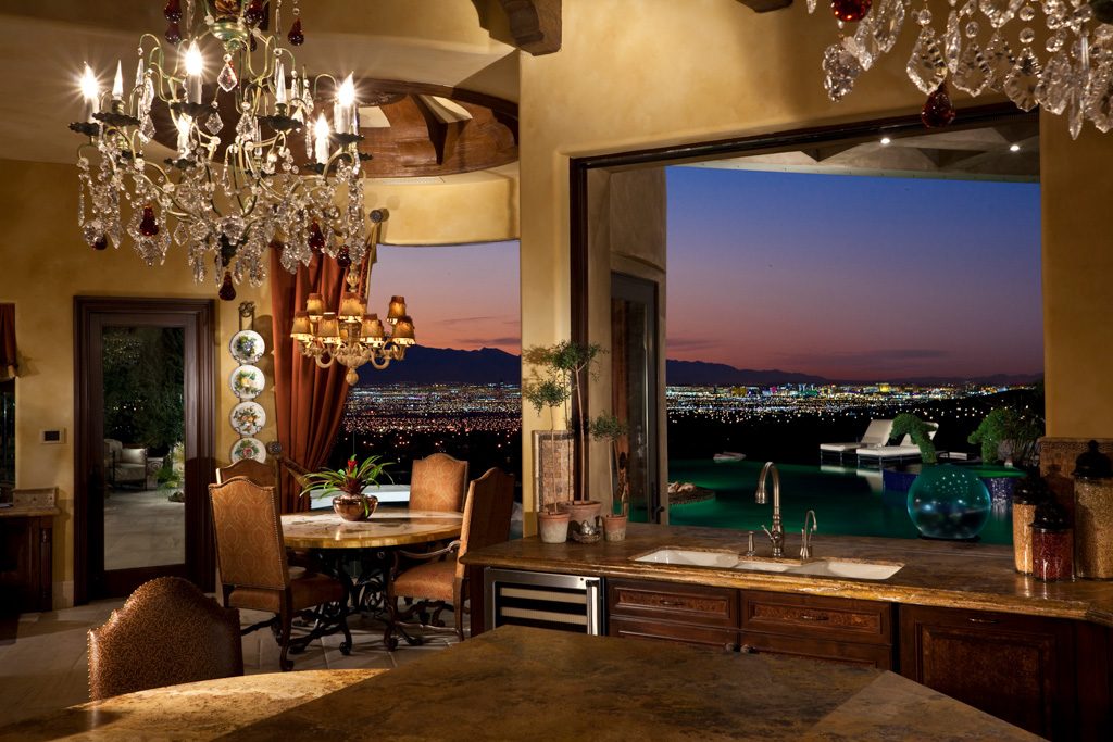 Dining room with chandelier and a window view of the Las Vegas Valley at dusk